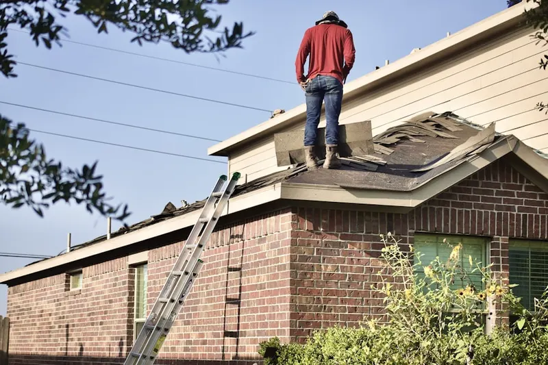 Professional roofer working on a residential roof in Hurlburt Field